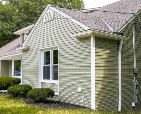 New siding for a house painted in light green olive color and new white high efficient double-hung vinyl windows Exterior Painting, Painting Contractors, residential painting, commercial painting, painting contractor near me, siding contractor