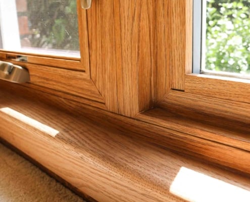 Natural wood color custom window with brass hardware and view to the natural landscape surrounding the house installation, Sliding door installation, Patio door installation, Front door installation, windows and doors installation, energy efficient windows and doors replacement